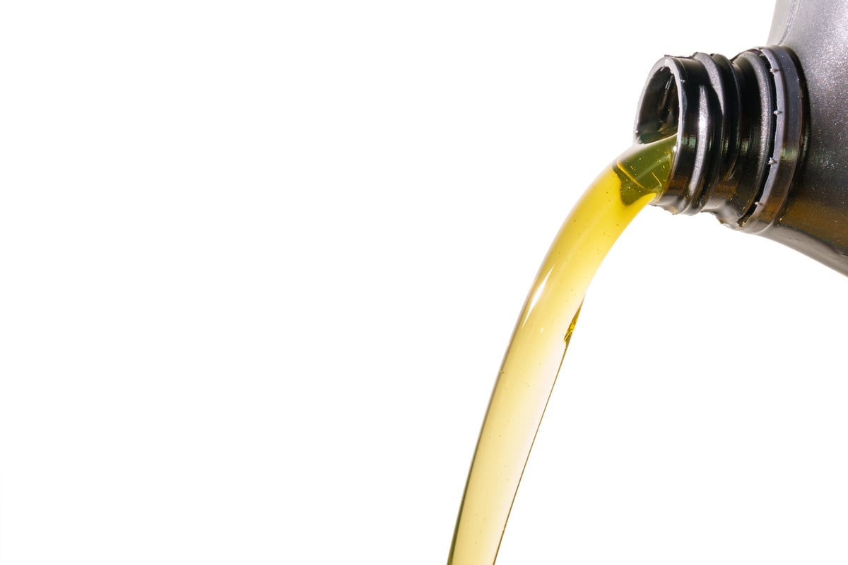 Pouring motor oil on white background